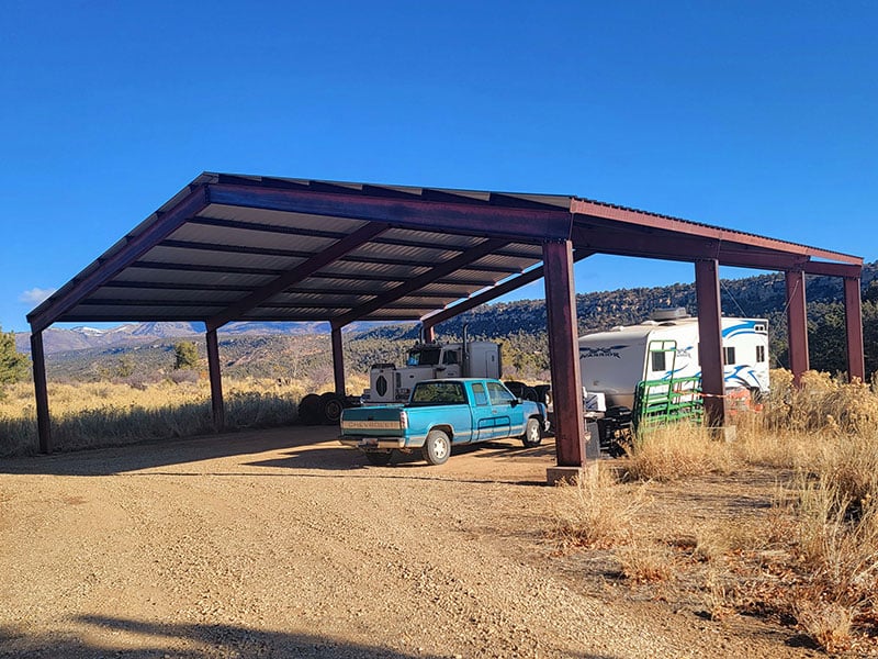 The pavilion with an rv and trucks underneath